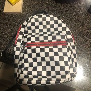 Checkered Mini backpack with red zipper.